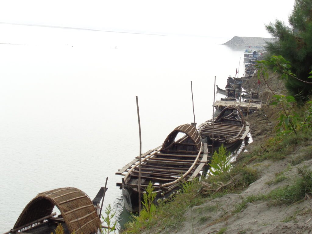A photo of some boats are tied to the bank of the river Brahmaputra