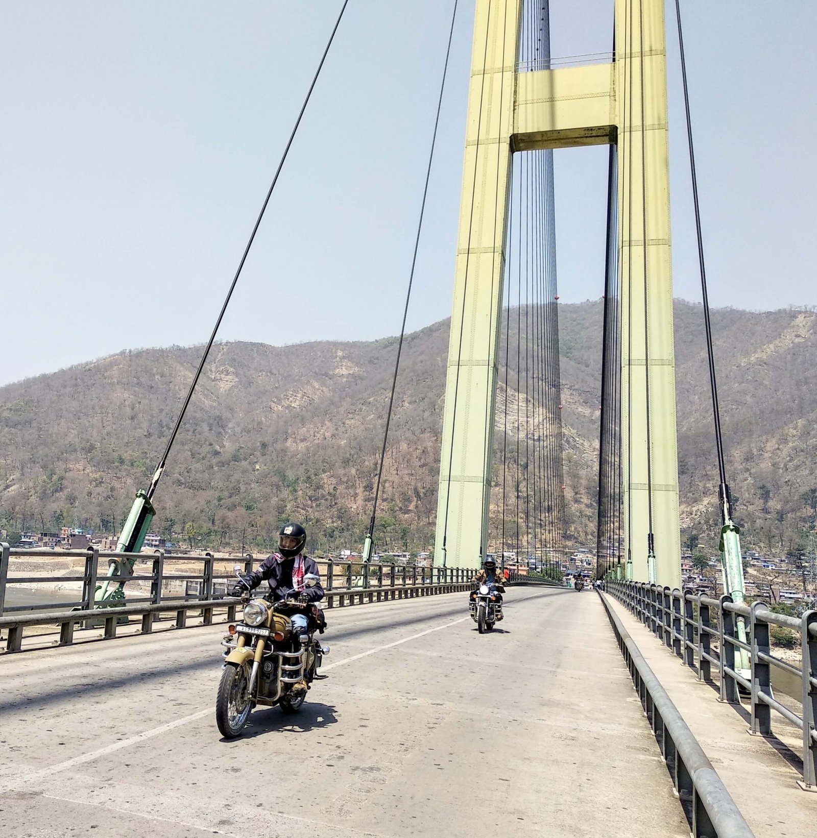 A rider riding a bike on a hanging bridge