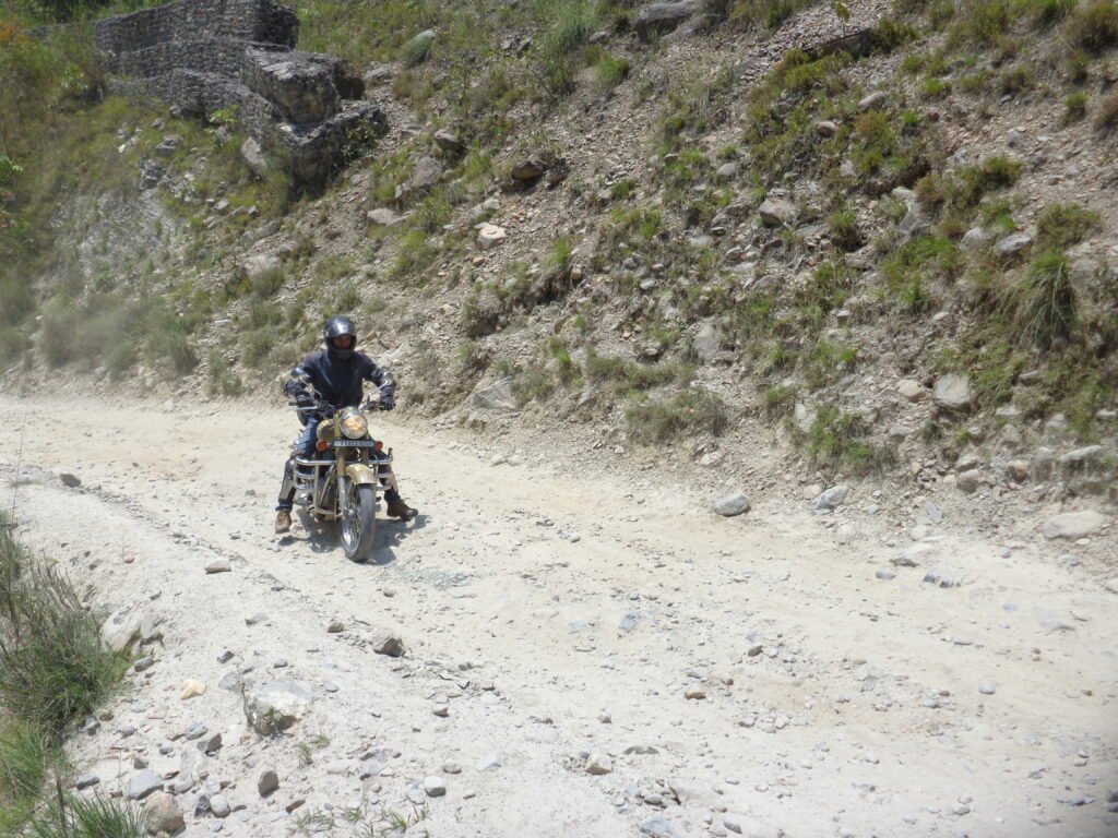 A rider trying to ride on a rough hilly road