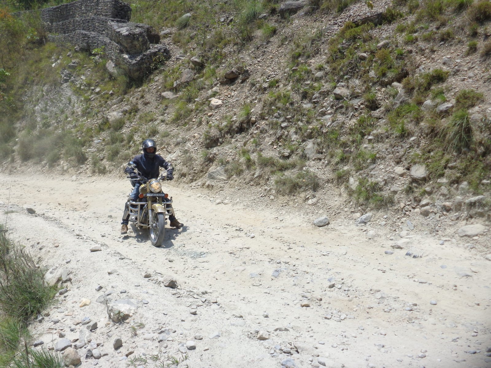 A rider trying to ride on a rough hilly road