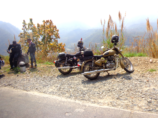 Two riders talking near two standing bikes