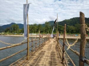 A photo od a bamboo bridge over a river