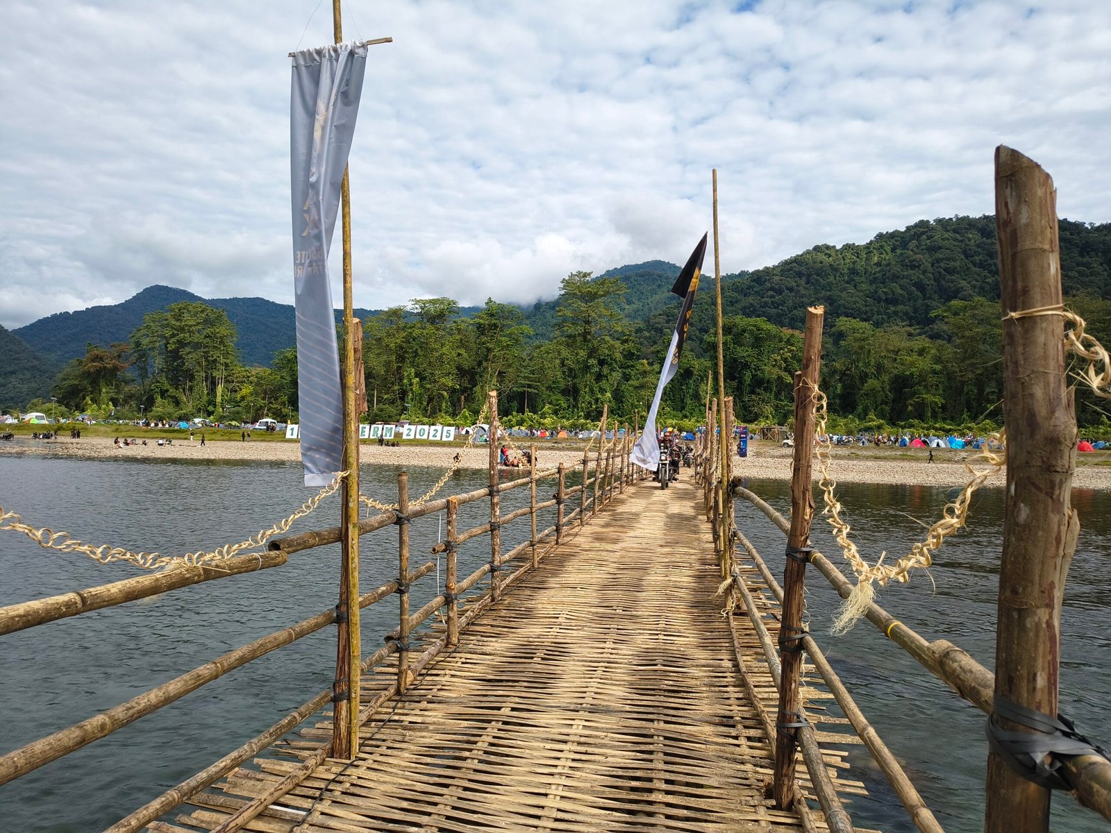A photo od a bamboo bridge over a river
